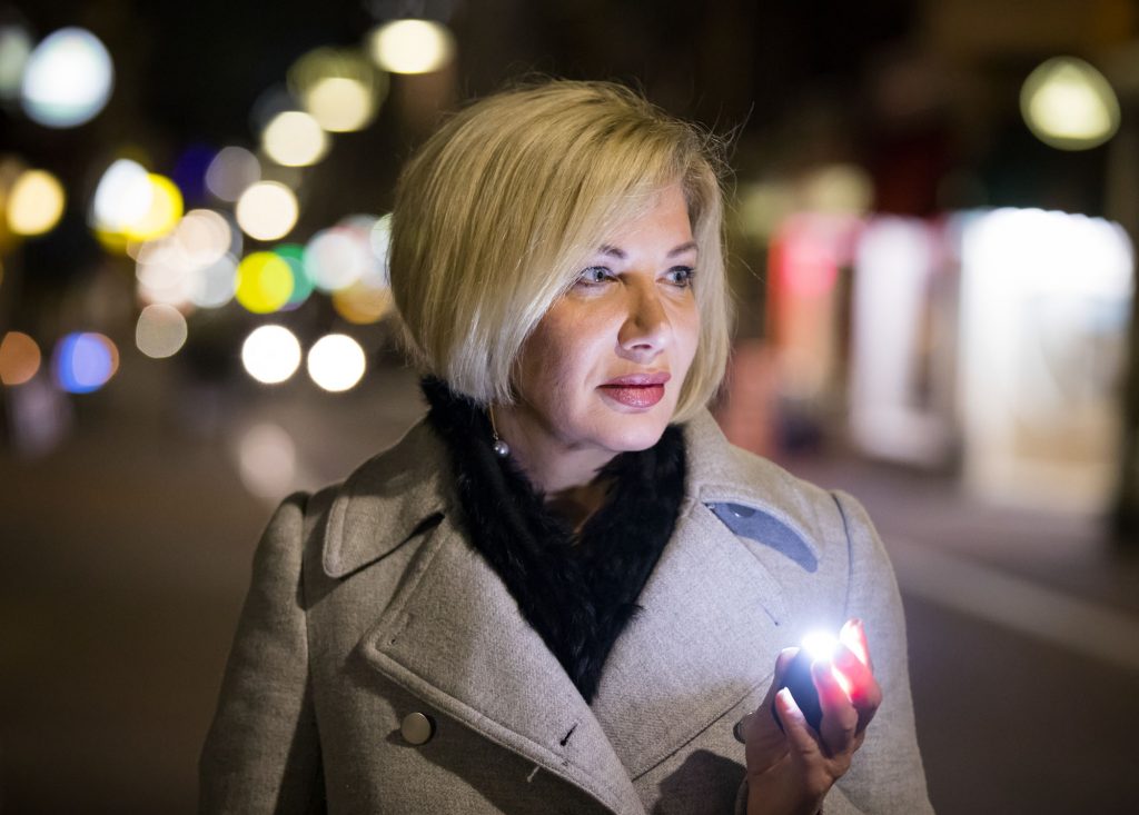This is an image of a women holding a WanderSafe Beacon https://www.wandersafe.com/product/beacon